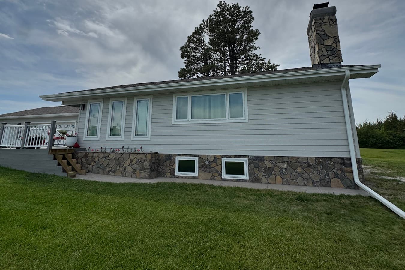 Home with stone chimney and stone foundation skirting finished by Gali Masonry